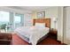 Comfortable bedroom featuring a king bed, ocean view balcony, and beachy accents at 504 N Ocean Blvd. # 1106, Myrtle Beach, SC 29577