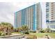 Modern Bay View condominium building with multiple balconies, grassy areas and palm trees at 504 N Ocean Blvd. # 1106, Myrtle Beach, SC 29577