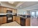 Modern kitchen is equipped with black appliances and light wood cabinets at 504 N Ocean Blvd. # 1106, Myrtle Beach, SC 29577