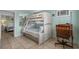 Bedroom featuring a charming bunk bed with an adjoining desk and ample natural light at 5409 N Ocean Blvd. # 100, North Myrtle Beach, SC 29582