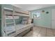 Bedroom featuring a charming bunk bed with an adjoining desk and natural light at 5409 N Ocean Blvd. # 100, North Myrtle Beach, SC 29582