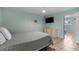 Bedroom with tiled floors, ceiling fan, TV, and a calming, light green color scheme at 5409 N Ocean Blvd. # 100, North Myrtle Beach, SC 29582