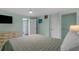 Bedroom with tiled floors, closet, TV, and a calming, light green color scheme at 5409 N Ocean Blvd. # 100, North Myrtle Beach, SC 29582