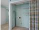 Spacious closet area featuring built-in shelving, a curtain, and access to the laundry at 5409 N Ocean Blvd. # 100, North Myrtle Beach, SC 29582