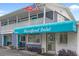 Charming two-story condo building featuring a distinctive blue awning and prominent street numbers at 5409 N Ocean Blvd. # 100, North Myrtle Beach, SC 29582