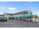 Charming exterior with blue awning and American flag displayed at 5409 N Ocean Blvd. # 100, North Myrtle Beach, SC 29582