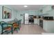 Modern kitchen with stainless steel appliances, cabinetry, and adjacent dining area with tile floors at 5409 N Ocean Blvd. # 100, North Myrtle Beach, SC 29582