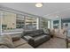 Bright living room with tile flooring, multiple sofas, and large windows offering plenty of natural light at 5409 N Ocean Blvd. # 100, North Myrtle Beach, SC 29582