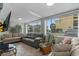 Spacious living room with comfortable sofas, large windows, and tile flooring at 5409 N Ocean Blvd. # 100, North Myrtle Beach, SC 29582