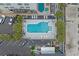 Aerial view of a community pool with ample seating and palm trees at 5409 N Ocean Blvd. # 100, North Myrtle Beach, SC 29582