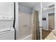 Bathroom featuring a stacked washer/dryer, shower/tub combination, and access to the adjacent space at 6001 - 1082 S Kings Hwy., Myrtle Beach, SC 29575