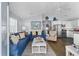 Open-concept living room boasts blue couches, vaulted ceilings, and beachy decor at 6001 - 1082 S Kings Hwy., Myrtle Beach, SC 29575