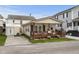 Charming home featuring a lovely front porch and a well-maintained yard, set against a beautiful blue sky at 6001-1453 S Kings Hwy., Myrtle Beach, SC 29575
