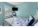 Inviting bedroom with a blue and white comforter, a window, and light blue walls, providing a peaceful ambiance at 6001-1808 S Kings Hwy., Myrtle Beach, SC 29575