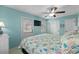 Comfortable bedroom with a sea-themed comforter, light blue walls, and a door to the backyard at 6001-1808 S Kings Hwy., Myrtle Beach, SC 29575