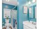 Bright bathroom featuring a shower, toilet, vanity, and blue accent walls, creating a refreshing ambiance at 6001-N2 S Kings Hwy., Myrtle Beach, SC 29575