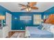 Comfortable bedroom with hardwood floors, a ceiling fan, and a soft, inviting bed with plush pillows at 6001-N2 S Kings Hwy., Myrtle Beach, SC 29575