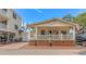 Charming home featuring a covered porch with decorative railings and a well-maintained lawn at 6001-N2 S Kings Hwy., Myrtle Beach, SC 29575