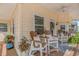 Relaxing porch area with outdoor seating and a ceiling fan at 6001-N2 S Kings Hwy., Myrtle Beach, SC 29575