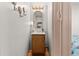 Compact bathroom featuring a wooden vanity, gold mirror, and light fixtures at 6001-T3 S Kings Hwy., Myrtle Beach, SC 29575