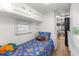 Comfortable bedroom with a blue comforter, bright decor and convenient built-in storage at 6001-T3 S Kings Hwy., Myrtle Beach, SC 29575