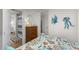 Well-lit bedroom featuring a comfortable bed, nautical art, and a glimpse of the adjoining bathroom at 6001-T3 S Kings Hwy., Myrtle Beach, SC 29575