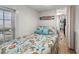 Bright bedroom with a bed, blue accents, natural light, and a glimpse into another room at 6001-T3 S Kings Hwy., Myrtle Beach, SC 29575