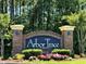 Arbor Trace community brick entrance sign with manicured landscaping and colorful flowers at 6015 Catalina Dr. # 732, North Myrtle Beach, SC 29582