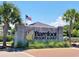 Barefoot Resort & Golf community entrance sign with palm trees and an American flag at 6015 Catalina Dr. # 732, North Myrtle Beach, SC 29582