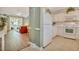 An open-concept kitchen featuring white cabinets and appliances, with a view to the living room at 6015 Catalina Dr. # 732, North Myrtle Beach, SC 29582