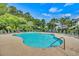 Large community swimming pool with plenty of seating, surrounded by trees and greenery at 6015 Catalina Dr. # 732, North Myrtle Beach, SC 29582
