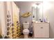 Charming bathroom with stylish patterned shower curtain and vanity with ample storage at 604 Heathrow Dr. # 1097, Myrtle Beach, SC 29579