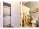 Full bathroom with stacked washer and dryer closet and designer patterned shower curtain at 604 Heathrow Dr. # 1097, Myrtle Beach, SC 29579