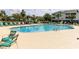 Large community pool surrounded by lounge chairs and lush landscaping under blue skies at 604 Heathrow Dr. # 1097, Myrtle Beach, SC 29579