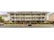 Three-story condo building showcasing balconies, staircases, brick accents, landscaping and parking area at 604 Heathrow Dr. # 1097, Myrtle Beach, SC 29579
