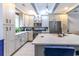 Stylish kitchen with white cabinets, granite countertops, stainless steel appliances, and a center island at 604 Heathrow Dr. # 1097, Myrtle Beach, SC 29579
