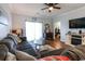 Cozy living room showcasing a large sectional sofa, warm wood floors, and natural light at 604 Heathrow Dr. # 1097, Myrtle Beach, SC 29579