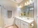 Bright bathroom with dual sink vanity, marble countertop, and white cabinets offering ample storage at 631 Rycola Circle, Surfside Beach, SC 29575
