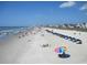 Wide sandy beach filled with people enjoying the sunshine, umbrellas, and the ocean breeze at 631 Rycola Circle, Surfside Beach, SC 29575