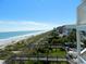 Beach view from a boardwalk with beach homes showcases coastal living and ocean access at 631 Rycola Circle, Surfside Beach, SC 29575