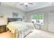 Bedroom features a tray ceiling, ceiling fan, and a bed with colorful quilt, plus a view out the window at 631 Rycola Circle, Surfside Beach, SC 29575