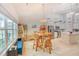 A dining area with wicker chairs sits adjacent to the kitchen and a large window adding brightness at 631 Rycola Circle, Surfside Beach, SC 29575