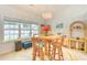 Bright dining area features a round table, wicker chairs, and a large window offering natural light at 631 Rycola Circle, Surfside Beach, SC 29575