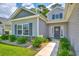 Attractive home with stone accents, manicured landscaping, and a welcoming entryway, with easy access to walking trails at 631 Rycola Circle, Surfside Beach, SC 29575