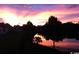 Scenic lake view at sunset with silhouettes of trees and houses reflecting in the water at 631 Rycola Circle, Surfside Beach, SC 29575