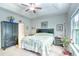 Cozy bedroom retreat featuring a trey ceiling, ceiling fan, light wood floors, large window and ample closet space at 631 Rycola Circle, Surfside Beach, SC 29575