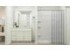 Modern bathroom featuring a walk-in shower, white vanity and ample storage space at 6344 Swainson Street Sw, Ocean Isle Beach, NC 28469
