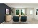 Living room with modern furniture, a wall-mounted television, and a view to outdoor scenery at 6344 Swainson Street Sw, Ocean Isle Beach, NC 28469