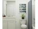Well-lit bathroom featuring a vanity with sink, a toilet, and a shower with a patterned curtain at 6362 Swainson Street Sw, Ocean Isle Beach, NC 28469