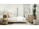 Light and airy bedroom boasting a cozy bed, stylish wallpaper, and a decorative houseplant at 6362 Swainson Street Sw, Ocean Isle Beach, NC 28469